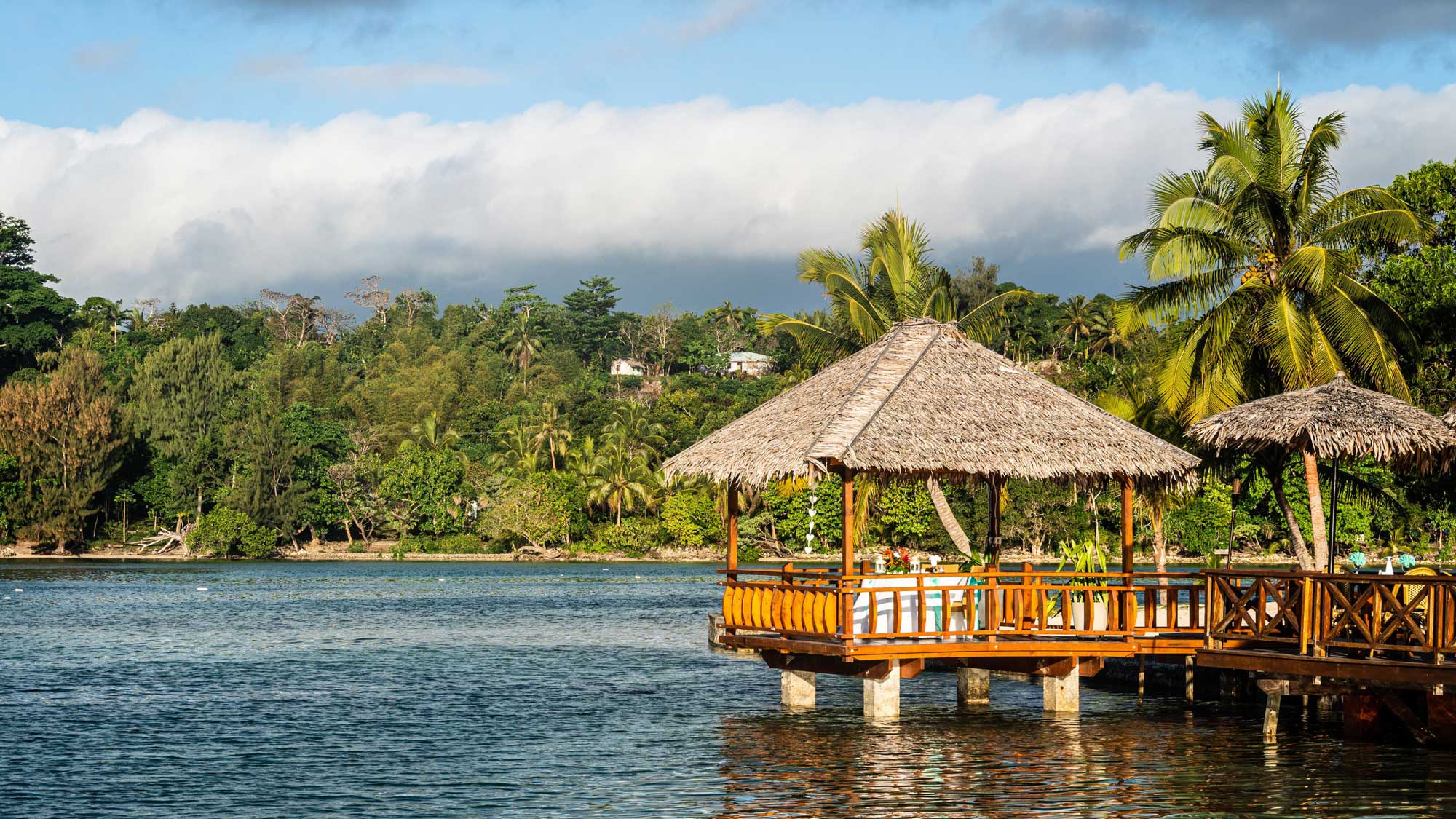 Tropical hut in the Port Vila lagoon, Vanuatu. Photo by jakartatravel via Adobe Stock.