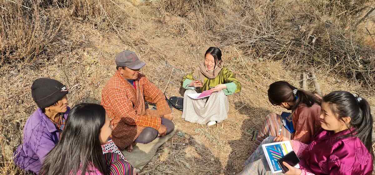 A researcher in Bhutan conducts an interview about rituals. Photo by Phanchung, 2023