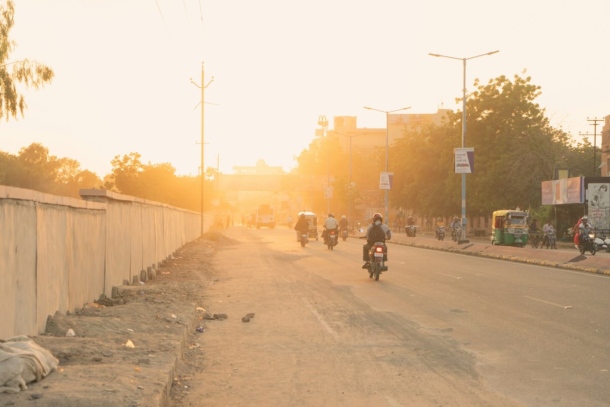 An Indian road at sunset. Photo by Brett Clouser (@brettclouser) on Unsplash.